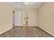 This bedroom features wood floors and access to a walk-in closet and an en-suite bathroom at 208 Lake Region S Blvd, Winter Haven, FL 33881