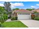 Charming single-story home with well-manicured lawn, tile roof, and a two-car garage at 208 Lake Region S Blvd, Winter Haven, FL 33881
