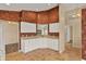 Traditional kitchen featuring white cabinets, tan counters, and a classic floral wallpaper at 208 Lake Region S Blvd, Winter Haven, FL 33881