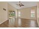 Living Room with ceiling fan, tile floors and slider doors leading to sunroom at 208 Lake Region S Blvd, Winter Haven, FL 33881