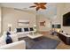 Living room featuring wood floors, fireplace, neutral walls, with a ceiling fan at 208 Lake Region S Blvd, Winter Haven, FL 33881