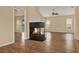 Spacious living room featuring wood floors, fireplace, neutral walls, and access to the sunroom at 208 Lake Region S Blvd, Winter Haven, FL 33881
