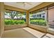 The patio has several large windows that look out onto the landscaping at 208 Lake Region S Blvd, Winter Haven, FL 33881