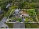 Aerial view of a property requiring significant renovation and clean up at 215 10Th Wahneta W St, Winter Haven, FL 33880