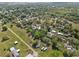Aerial view showing the house needing major repairs among greenery at 215 10Th Wahneta W St, Winter Haven, FL 33880