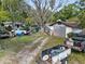 Messy backyard with multiple vehicles and debris at 215 10Th Wahneta W St, Winter Haven, FL 33880