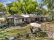 Messy backyard with multiple structures and outdoor furniture at 215 10Th Wahneta W St, Winter Haven, FL 33880