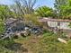 The exterior of a home needing extensive repairs, with trash and debris at 215 10Th Wahneta W St, Winter Haven, FL 33880