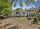Messy yard with old mobile home and debris at 215 10Th Wahneta W St, Winter Haven, FL 33880