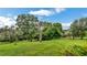 Scenic backyard with mature trees and sprawling lawn at 2300 N Scenic Hwy # 56, Lake Wales, FL 33898