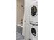 Tiled bathtub and shower combination with a stackable washer and dryer unit at 2300 N Scenic Hwy # 56, Lake Wales, FL 33898