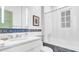 Bright bathroom features a tub with shower and patterned tiles at 2300 N Scenic Hwy # 56, Lake Wales, FL 33898