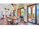 Spacious dining room with a long wooden table, arched ceilings, and access to an outdoor patio at 2300 N Scenic Hwy # 56, Lake Wales, FL 33898