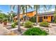 Beautiful home exterior featuring an expansive garden with lush greenery, palm trees, and ample outdoor seating at 2300 N Scenic Hwy # 56, Lake Wales, FL 33898