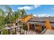 Stunning exterior view of a yellow home with palm trees, blue awnings, and a charming courtyard at 2300 N Scenic Hwy # 56, Lake Wales, FL 33898