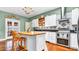 Inviting kitchen with white cabinets, an island, and a stainless-steel oven and range at 2300 N Scenic Hwy # 56, Lake Wales, FL 33898