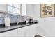 Modern kitchen with white cabinetry, sleek countertops, stainless steel sink, and a stylish backsplash at 2300 N Scenic Hwy # 56, Lake Wales, FL 33898