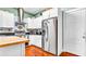 Well-lit kitchen featuring stainless steel appliances, light countertops, and sleek white cabinets at 2300 N Scenic Hwy # 56, Lake Wales, FL 33898