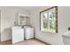 A laundry room with a tile floor, appliances, cabinet and a decorated window at 2300 N Scenic Hwy # 56, Lake Wales, FL 33898