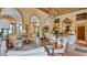 Elegant living room showcasing high ceilings, arched doorways, and a crystal chandelier at 2300 N Scenic Hwy # 56, Lake Wales, FL 33898