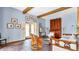 Living room with brick flooring, wooden beams, and access to the outdoor patio through the french doors at 2300 N Scenic Hwy # 56, Lake Wales, FL 33898