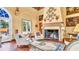Bright living room with decorative fireplace, arched entryway, and two white chairs at 2300 N Scenic Hwy # 56, Lake Wales, FL 33898