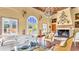 Stylish living room with a fireplace, grand chandelier, and beautiful windows overlooking the outdoors at 2300 N Scenic Hwy # 56, Lake Wales, FL 33898
