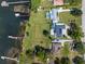 Stunning bird's eye view featuring lakefront property, large yard, and private boat docks at 2350 Crump Rd, Winter Haven, FL 33881