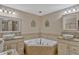 Bright bathroom featuring double vanities and a corner bathtub at 2350 Crump Rd, Winter Haven, FL 33881