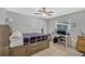 Bedroom with a window, ceiling fan, tiled floor, and desk area; great natural light at 2350 Crump Rd, Winter Haven, FL 33881