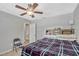 Bedroom with a window, ceiling fan, tiled floor, and built-in shelves in the headboard at 2350 Crump Rd, Winter Haven, FL 33881