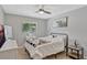 This bedroom features a window, ceiling fan, neutral paint and decor, and tiled floors at 2350 Crump Rd, Winter Haven, FL 33881