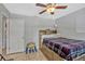 Bedroom with a window, ceiling fan, tiled floor, and built-in shelves in the headboard at 2350 Crump Rd, Winter Haven, FL 33881