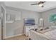 Comfortable bedroom offering a window, ceiling fan, neutral paint and decor, and tiled floors at 2350 Crump Rd, Winter Haven, FL 33881