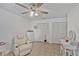 Bright bedroom features tiled floors, white walls, ceiling fan, and large, built-in storage with multiple closets at 2350 Crump Rd, Winter Haven, FL 33881