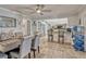 Open concept dining area with tile flooring, modern ceiling fan, and bar seating to the kitchen at 2350 Crump Rd, Winter Haven, FL 33881