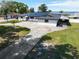 Beautiful home featuring solar panels, a spacious driveway, and well-manicured front yard at 2350 Crump Rd, Winter Haven, FL 33881