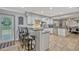 Well-lit kitchen featuring white cabinets, granite countertops, stainless steel appliances, and bar seating at 2350 Crump Rd, Winter Haven, FL 33881