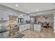 Kitchen with white cabinets, stainless steel appliances, dark countertops, and a view of the dining area at 2350 Crump Rd, Winter Haven, FL 33881
