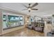 Inviting living room with a bay window overlooking the lake, comfortable seating, and tile flooring at 2350 Crump Rd, Winter Haven, FL 33881