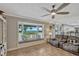Bright living room featuring tile floors, a large bay window overlooking the lake, and neutral decor at 2350 Crump Rd, Winter Haven, FL 33881