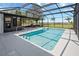 Large in-ground screened pool area with outdoor furniture, water views, and bright natural light at 2350 Crump Rd, Winter Haven, FL 33881