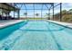 Sparkling screened-in pool with beautiful water views, perfect for relaxation and entertaining at 2350 Crump Rd, Winter Haven, FL 33881