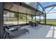 Enclosed outdoor patio area with lounge furniture, tables, and views of the lake at 2350 Crump Rd, Winter Haven, FL 33881