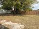 Picture of a large backyard that is partially fenced with mature trees at 253 Walter Ave, Frostproof, FL 33843