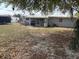 Large backyard with mature trees and a view of the house with a metal roof at 253 Walter Ave, Frostproof, FL 33843