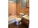 Bathroom with tiled walls, tub, toilet, and sink at 253 Walter Ave, Frostproof, FL 33843
