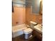 Bathroom with tiled walls, tub, toilet, and sink at 253 Walter Ave, Frostproof, FL 33843