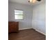 Bedroom with hardwood floors, dresser, and one window at 253 Walter Ave, Frostproof, FL 33843