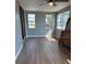 Bedroom featuring dark-look laminate floors and ample sunlight at 253 Walter Ave, Frostproof, FL 33843